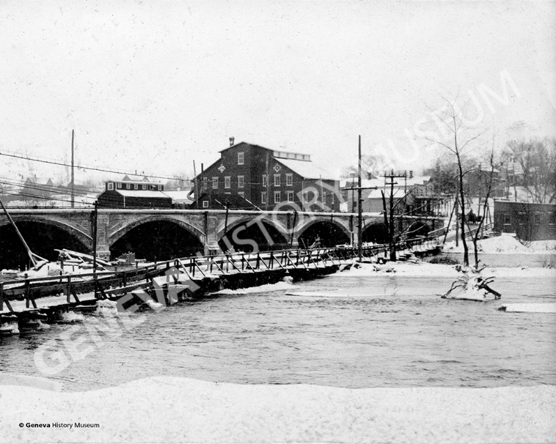 Product Description: Circa 1909 - View of the State Street Bridge Construction from the west bank of the Fox River looking east; Bennett Mill is showing in the background.</br></br>Available sizes:</br></br>8 x 10 = $20.00; 11 x 14 = $30.00; 16 x 20 = $40.00; 20 x 30 = $55.00; 24 x 36 = $65.00</br></br>In-store pickup free. Shipping available.</br> No. 4 - View of the State Street Bridge Constructi