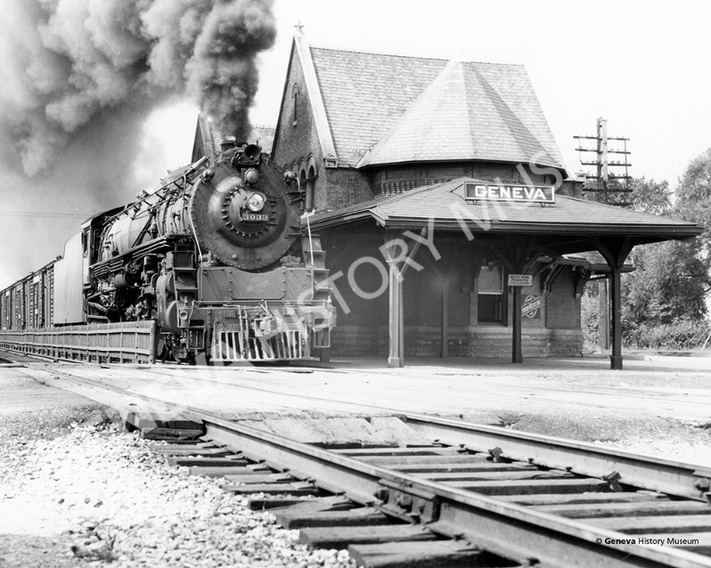 Product Description: Circa 1940s, locomotive steam engine pulling into the Geneva Train Depot. The Victorian style depot was built in 1892 and was demolished in 1960. In 1986, the present day depot was designed and constructed to echo the 1892 structure.</br></br>Available sizes:</br></br>8 x 10 = $20.00; 11 x 14 = $30.00; 16 x 20 = $40.00; 20 x 30 = $55.00; 24 x 36 = $65.00</br></br>In-store pickup free. Shipping available.</br> No. 10 - Geneva Train Depot, Circa 1940s